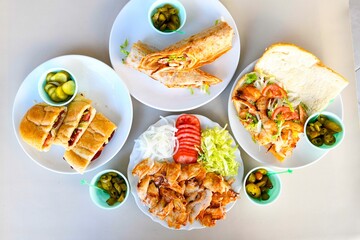 Delicious meat kebab with fresh vegetable salad served with variety of Turkish dishes and appetizers. Top view of assorted Turkish food and meze, tasty and healthy Mediterranean cuisine.