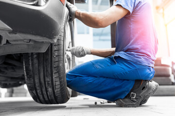 Concept banner service car wheel, changing sport summer tire on machine at station with sunlight