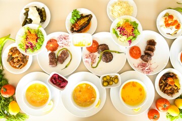 Delicious meat kebab with fresh vegetable salad served with variety of Turkish dishes and appetizers. Top view of assorted Turkish food and meze, tasty and healthy Mediterranean cuisine.