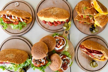 Delicious meat kebab with fresh vegetable salad served with variety of Turkish dishes and appetizers. Top view of assorted Turkish food and meze, tasty and healthy Mediterranean cuisine.