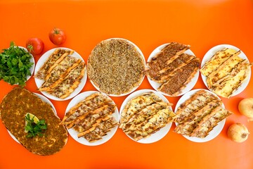 Delicious meat kebab with fresh vegetable salad served with variety of Turkish dishes and appetizers. Top view of assorted Turkish food and meze, tasty and healthy Mediterranean cuisine.