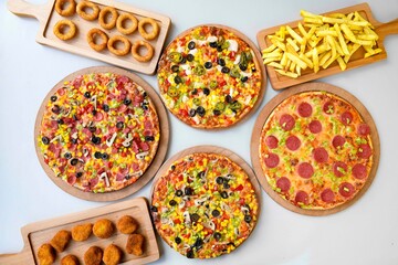 Delicious mixed pizza with rich content. Menu concept of choice and diversity. Sucuklu, Mantarli, karisik, akdeniz pizza