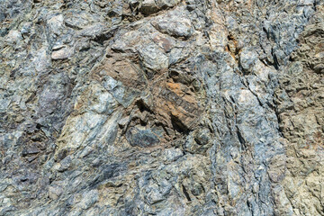 Fragment of rock in cracks. Close-up of a mountain.