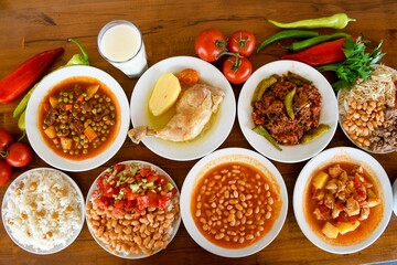 Delicious meat kebab with fresh vegetable salad served with variety of Turkish dishes and appetizers. Top view of assorted Turkish food and meze, tasty and healthy Mediterranean cuisine.