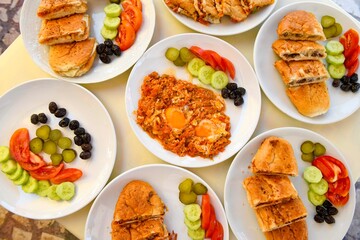 Delicious meat kebab with fresh vegetable salad served with variety of Turkish dishes and appetizers. Top view of assorted Turkish food and meze, tasty and healthy Mediterranean cuisine.