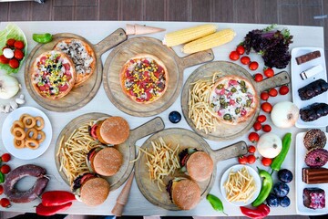 Traditional Turkish cuisine. Pizza, pita, pidesi, sucuk, hummus, kebab. Many dishes on the table. Serving dishes in restaurant. Background image. Top view, flat lay