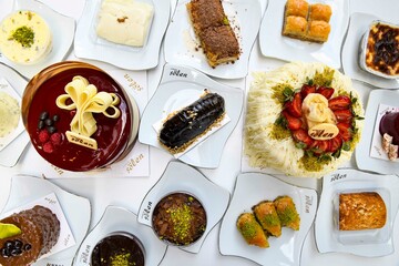 Traditional Turkish cuisine. Pizza, pita, pidesi, sucuk, hummus, kebab. Many dishes on the table. Serving dishes in restaurant. Background image. Top view, flat lay