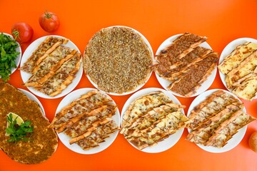 Delicious meat kebab with fresh vegetable salad served with variety of Turkish dishes and appetizers. Top view of assorted Turkish food and meze, tasty and healthy Mediterranean cuisine.