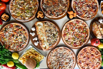 Traditional Turkish cuisine. Pizza, pita, pidesi, sucuk, hummus, kebab. Many dishes on the table. Serving dishes in restaurant. Background image. Top view, flat lay