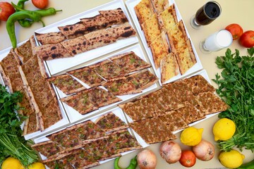 Delicious meat kebab with fresh vegetable salad served with variety of Turkish dishes and appetizers. Top view of assorted Turkish food and meze, tasty and healthy Mediterranean cuisine.