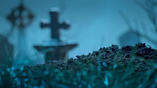 Zombie hand rises from the grave, points her finger at you and calling to him. Holiday event halloween concept.