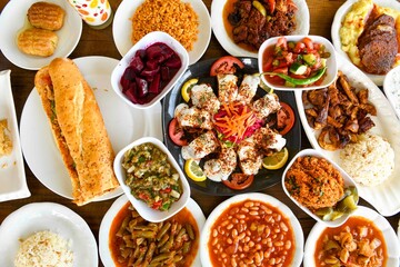 Traditional Turkish cuisine. Pizza, pita, pidesi, sucuk, hummus, kebab. Many dishes on the table. Serving dishes in restaurant. Background image. Top view, flat lay