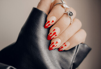 Beautiful art manicure. Halloween manicure design ideas. Fashionable valentines day nail design. Stylish red nails. Close up photo. - obrazy, fototapety, plakaty