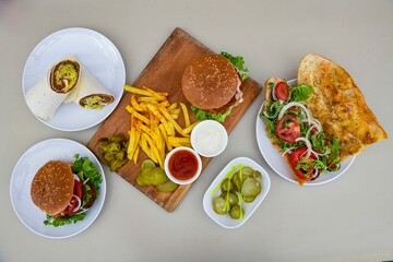Delicious meat kebab with fresh vegetable salad served with variety of Turkish dishes and appetizers. Top view of assorted Turkish food and meze, tasty and healthy Mediterranean cuisine.