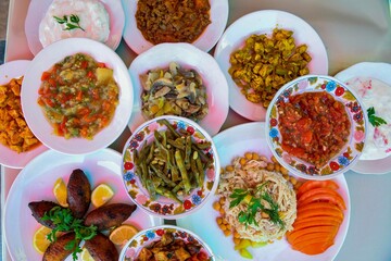 Delicious meat kebab with fresh vegetable salad served with variety of Turkish dishes and appetizers. Top view of assorted Turkish food and meze, tasty and healthy Mediterranean cuisine.