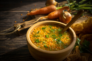 Lentil soup on a wooden background