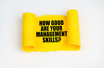 On a white surface, a yellow scroll of paper with the inscription - HOW GOOD ARE YOUR MANAGEMENT SKILLS
