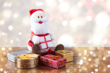 Santa Claus with gifts and blurred background with lights