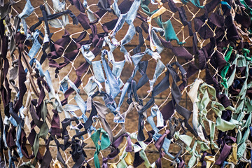 abstract background from a camouflage military mesh close-up. war in Ukraine.