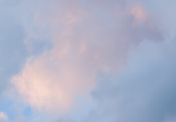 Fototapeta na wymiar Blue sky background with pale pink clouds at sunset