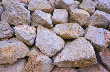 Texture of a stone wall. Old castle stone wall texture background. Brown, sienna large stones. Part of a stone wall, for background or texture