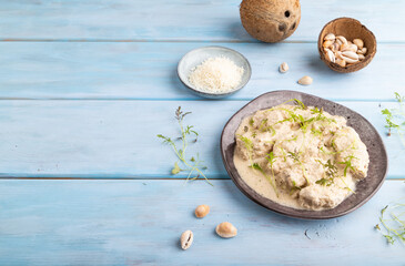 Stewed chicken fillets with coconut milk sauce. side view, copy space.
