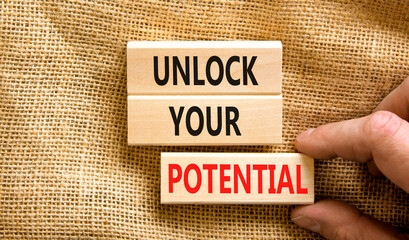 Unlock your potential symbol. Concept words Unlock your potential on wooden blocks. Businessman hand. Beautiful canvas background. Business, psychological unlock your potential concept. Copy space.