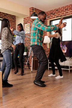 Young Adult African American Male Vertical Shot Dancing At Various Ethnicities People Party, Gathering, Reunion. Different Nationalities Friends Group Drinking Wine, Enjoying Friendship.