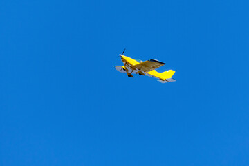 Yellow airplane. Transportation.Blue Sky.