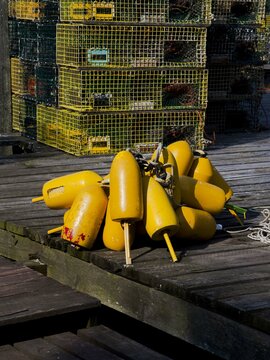 Yellow Buoys On A Dock With Lobster Traps In The Background