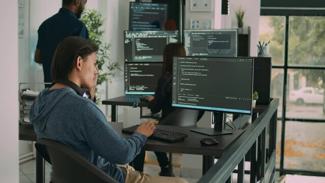 Asian software engineer working on security program with server code, typing system information on computer screen. Database programer writing code with algorithms, it language.