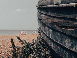 Remains old wooden boat rotting away in foreground on Brighton Beach