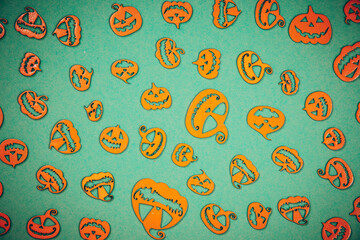 Halloween carved in wood Pumpkins pattern on colored background.