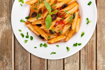 Italian Traditional Dish Pasta a on plate with wooden table background.