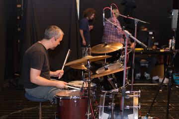 Music band playing music and rehearsing in recording studio