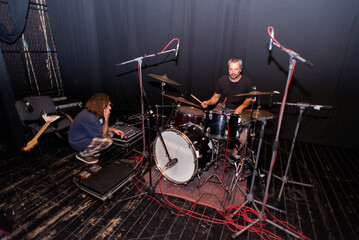 Fototapeta na wymiar Rock band recording their music in the professional recording studio