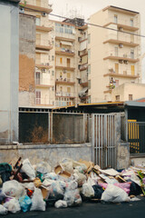 Garbage bags pile up on a residential street in Catania, Italy