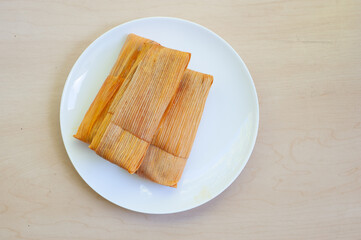 Three Tamales on a plate