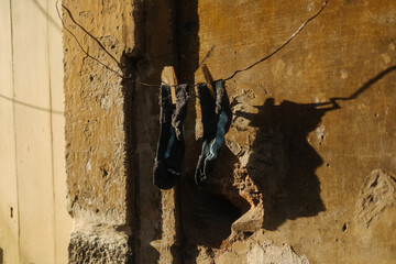 socks are hung to dry in front of an old facade