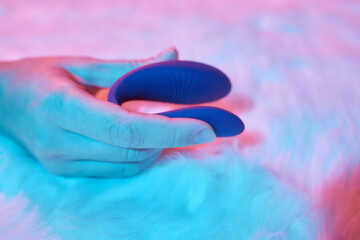 desire concept : Woman lying in bed holding a dildo vibrator in her hand to help herself.