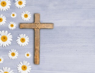 Christian cross and border of flowers on a desk background