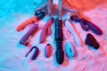 desire concept : Woman lying in bed holding a dildo vibrator in her hand to help herself. - obrazy, fototapety, plakaty
