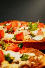 Mexican Molletes, traditional food with bread, beans, cheese, tomato and chili