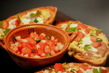 Mexican Molletes, traditional food with bread, beans, cheese, tomato and chili