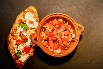 Mexican Molletes, traditional food with bread, beans, cheese, tomato and chili