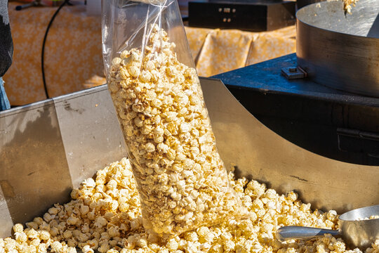 A bag of kettle corn popcorn being filled at the local county fair.