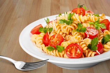 Italian Traditional Dish Pasta a on plate with wooden table background.