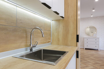 Faucet and steel sink in the kitchen