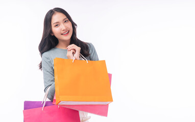Enjoyment excited asian woman carry shopping bags standing on white background. Trendy happy...