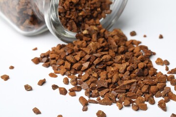 Overturned jar with chicory granules on white background, closeup